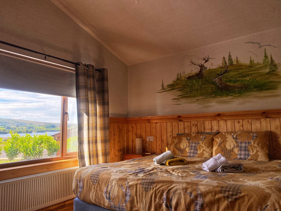 A bedroom featuring a bed with blankets and towels at No 4 in Enniskillen