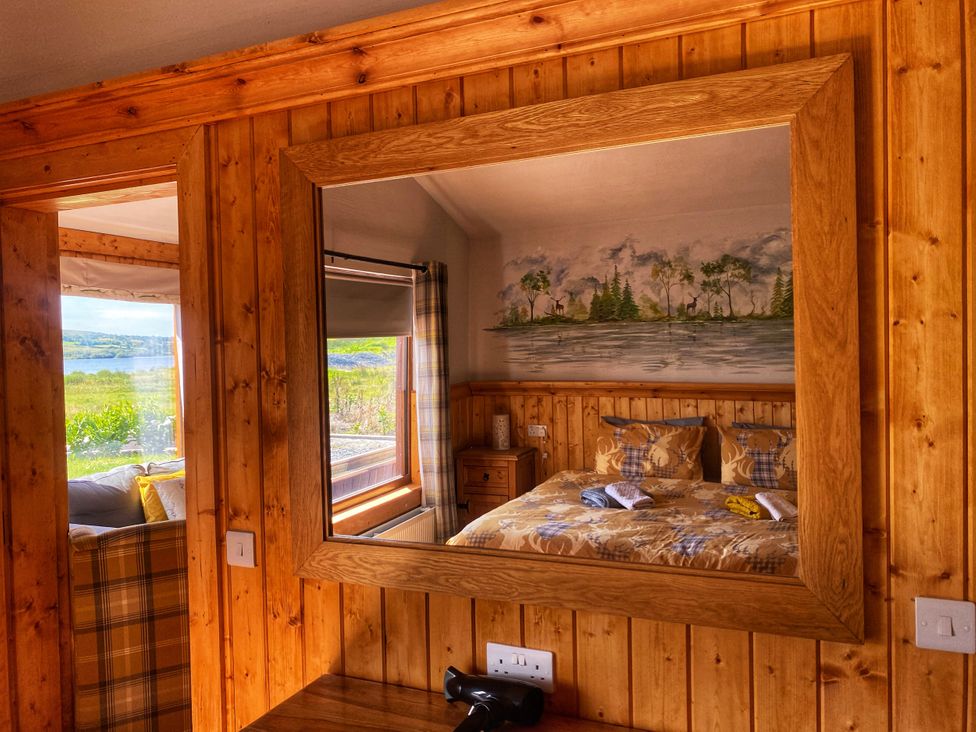 A bedroom with a bed and a mirror at No 6 Enniskillen