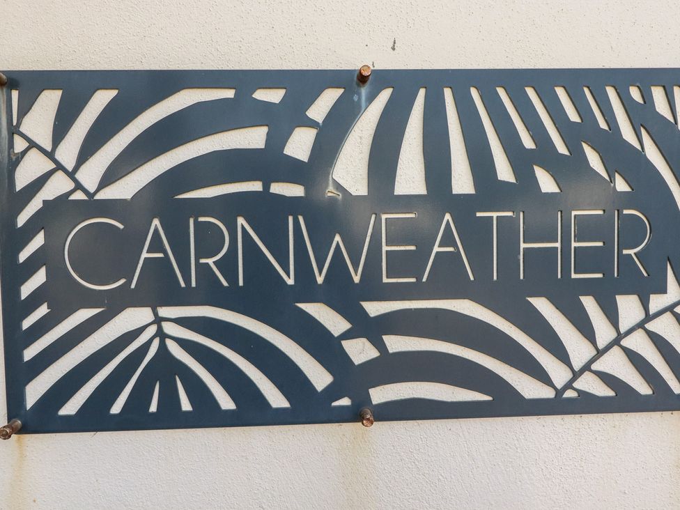 A decorative sign displaying the name 'CARNWEATHER' at Carnweather in Newquay