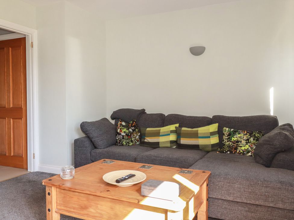 A living room with a sofa and coffee table at Carnweather in Newquay