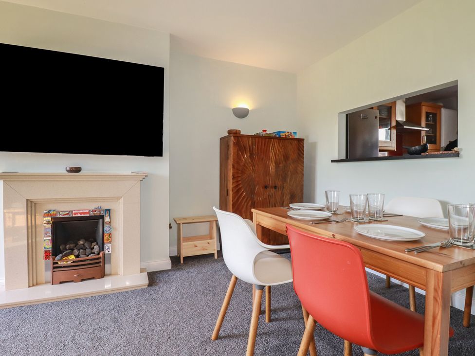 A dining room with a table and chairs at Carnweather in Newquay