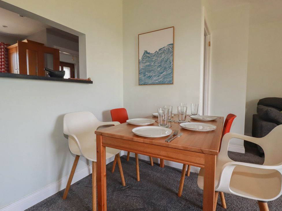 A dining room with a table set for a meal at Carnweather in Newquay