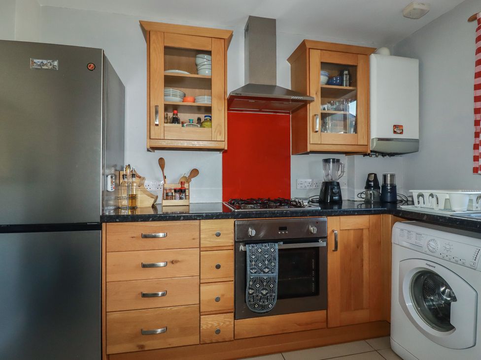 A kitchen with appliances and cabinets at Carnweather in Newquay