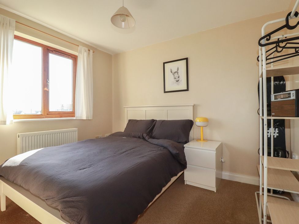 A bedroom with a bed and window at Carnweather in Newquay