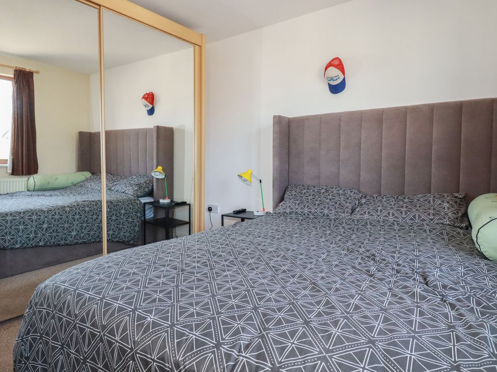 A bedroom with a bed and bedside table at Carnweather in Newquay