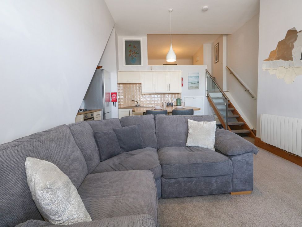 A living room with a sofa and kitchen area at Chandlers Nook in Portland