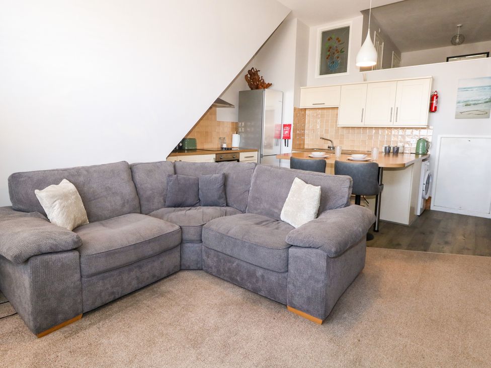 A living room with a sofa and kitchen in Chandlers Nook Portland