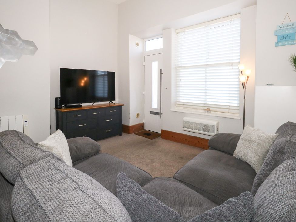 A living room with a television and sofa at Chandlers Nook in Portland