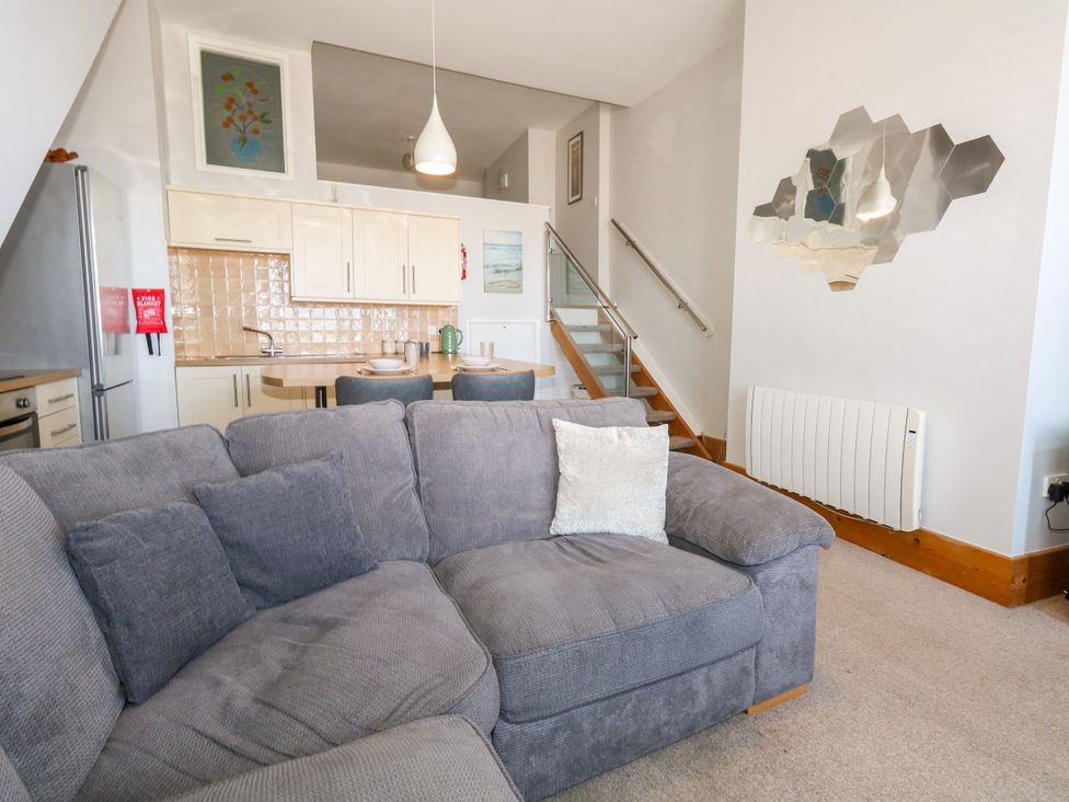 A living room with a sofa and kitchen area at Chandlers Nook in Portland