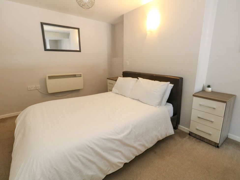 A bedroom with a bed and nightstand at Chandlers Nook in Portland