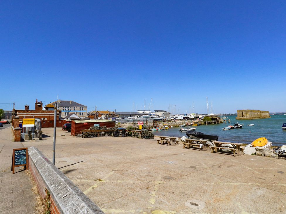 A waterfront view with boats and benches at Chandlers Nook in Portland