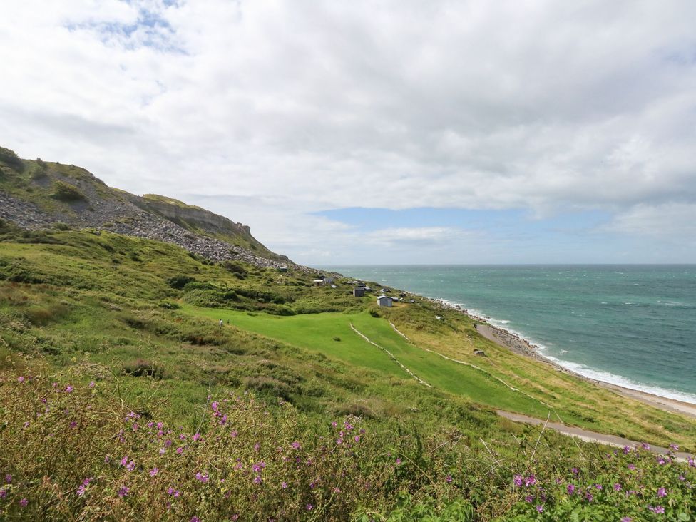 A coastal landscape with cliffs and ocean at Chandlers Nook in Portland