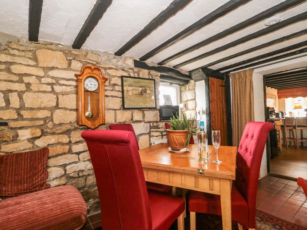 A dining room with a table and chairs at The Annexe at Cherry Cottage Upton St Leonards