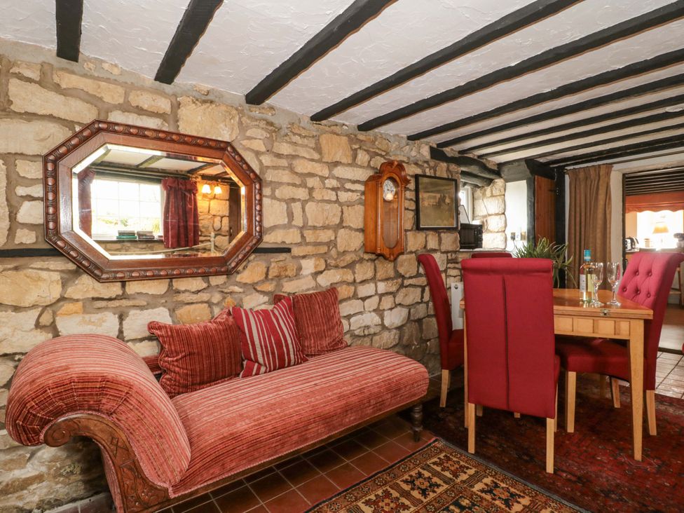 A dining room with a sofa and dining table at The Annexe at Cherry Cottage Upton St Leonards