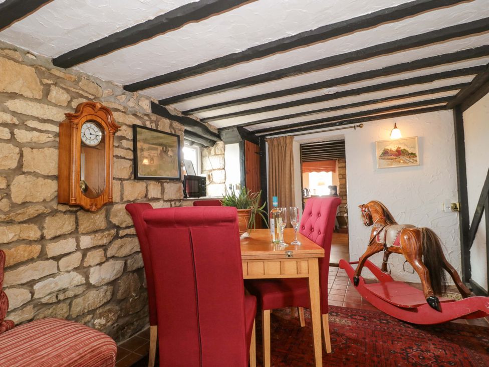 A dining room with a table and chairs at The Annexe at Cherry Cottage Upton St Leonards