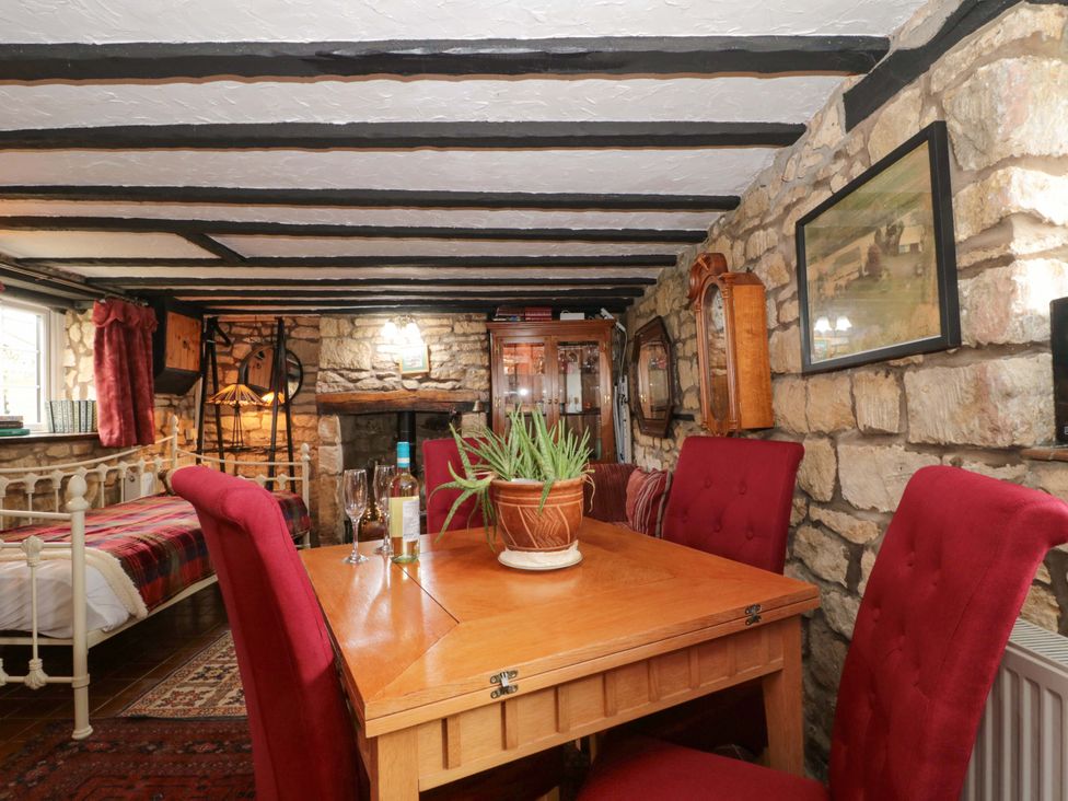 A dining room with a table and chairs at The Annexe at Cherry Cottage Upton St Leonards