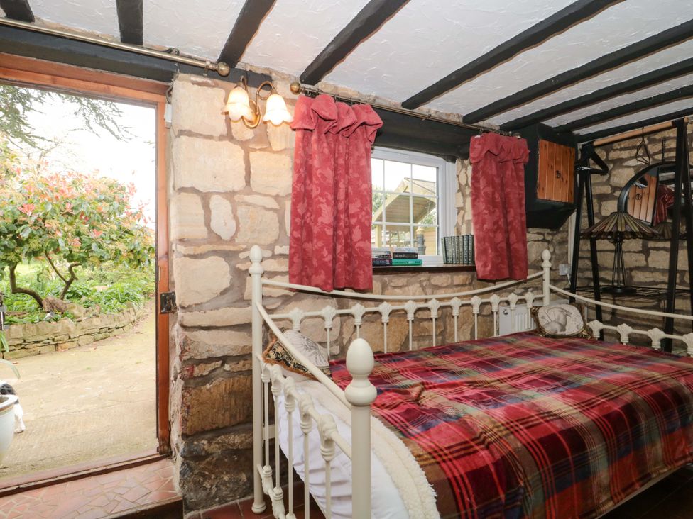 A bedroom with a bed and window at The Annexe at Cherry Cottage Upton St Leonards