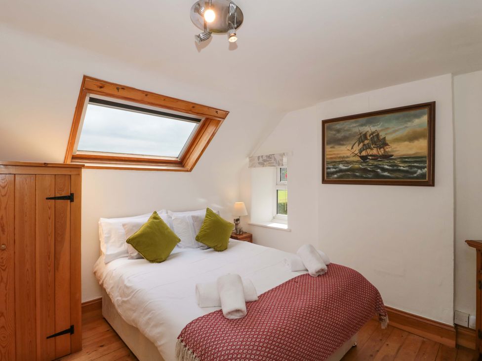A bedroom with a bed and window at The Annexe at Cherry Cottage Upton St Leonards