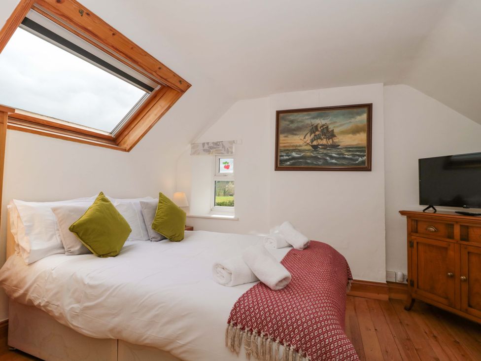 A bedroom with a bed and a television at The Annexe at Cherry Cottage Upton St Leonards