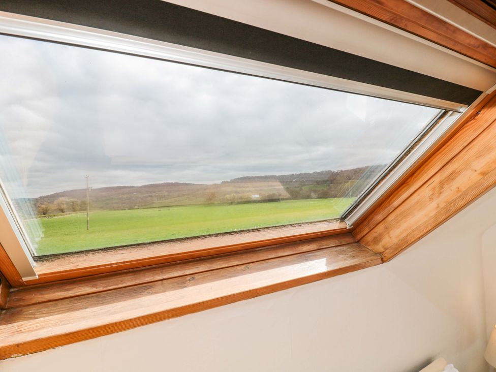 A window with a view of hills and fields at The Annexe at Cherry Cottage Upton St Leonards