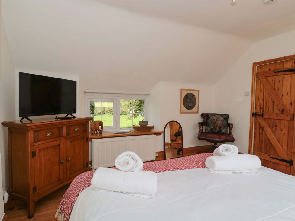 A bedroom with a television and a chest of drawers at The Annexe at Cherry Cottage Upton St Leonards