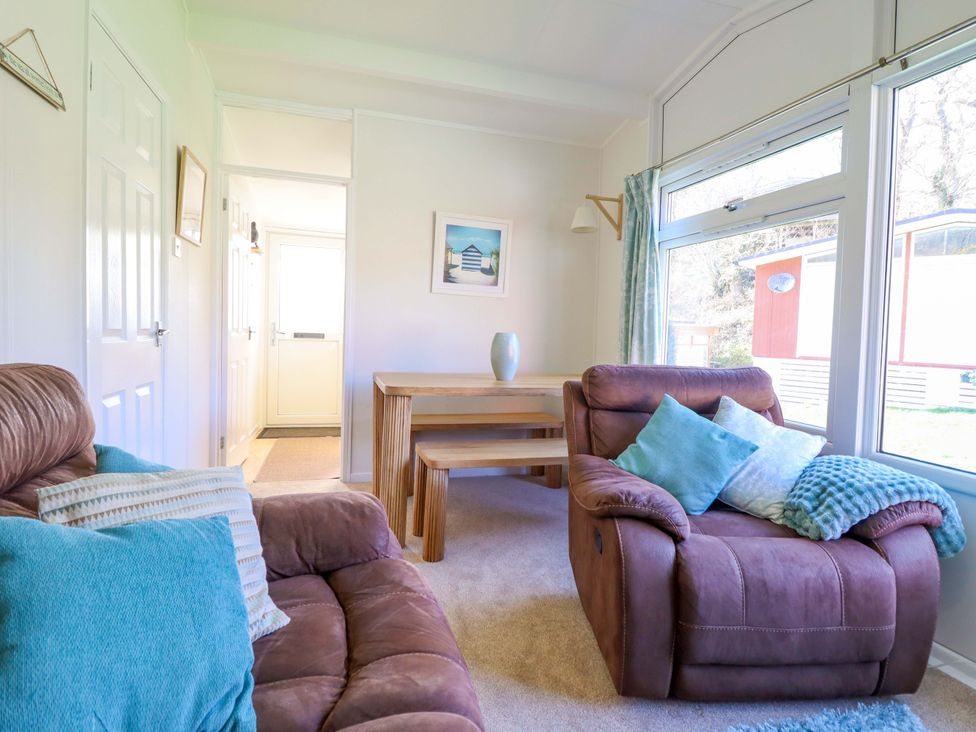 A living room with a sofa and table at Chalet 23 Erw Porthor Tywyn
