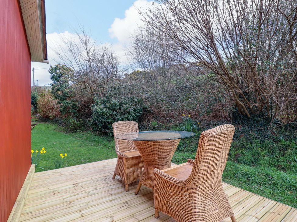 An outdoor area with a table and chairs at Chalet 23 Erw Porthor Tywyn