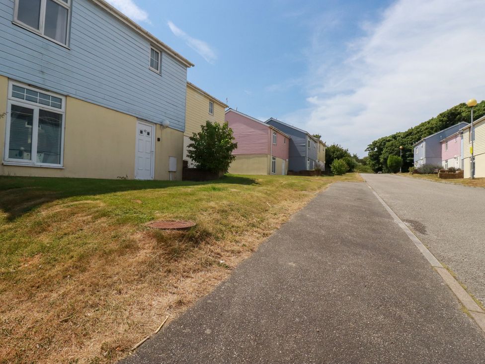 A street view of houses with grass and trees at 62 Golf Lodges Atlantic Reach near Fraddon