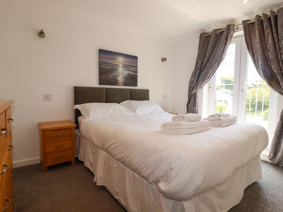 A bedroom with a bed and nightstand at 62 Golf Lodges Atlantic Reach near Fraddon