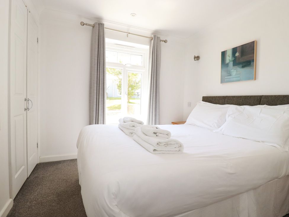 A bedroom with a bed and window at 62 Golf Lodges in Atlantic Reach near Fraddon
