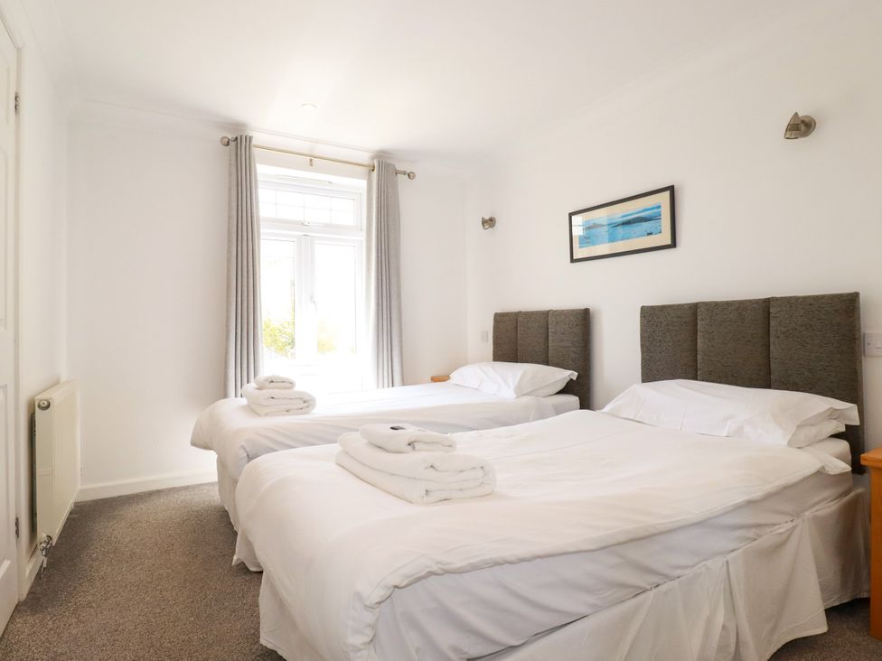A bedroom with two beds and a window at 62 Golf Lodges Atlantic Reach near Fraddon