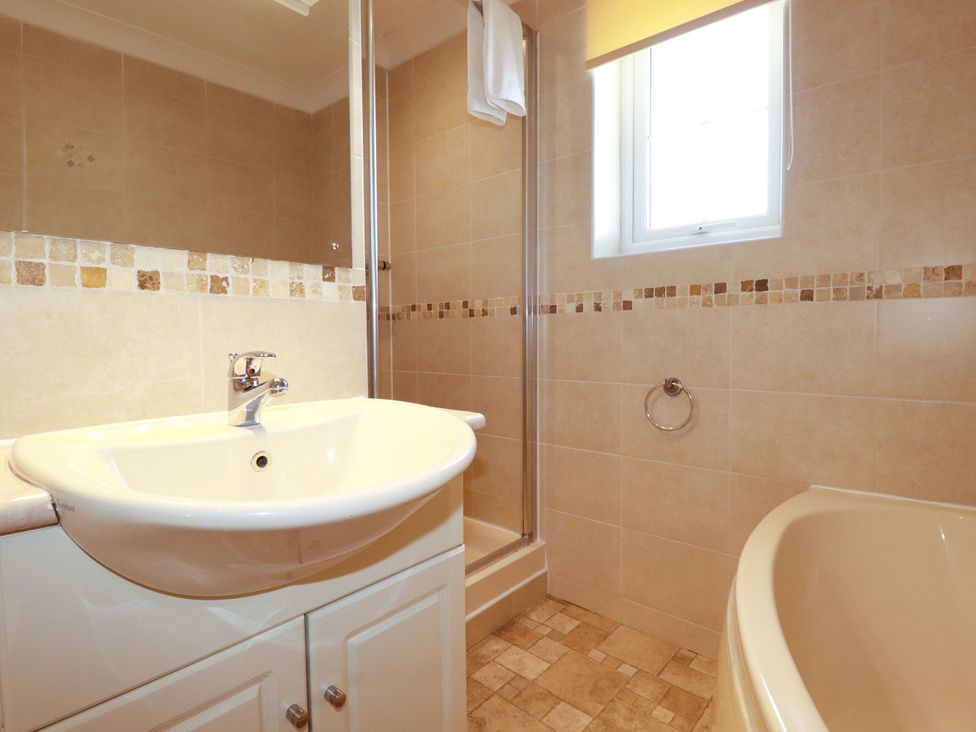 A bathroom with a sink, shower, and bathtub at 62 Golf Lodges, Atlantic Reach near Fraddon