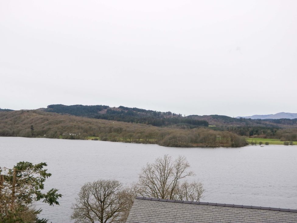 A view of a lake surrounded by trees and hills at Wilders Wood Windermere