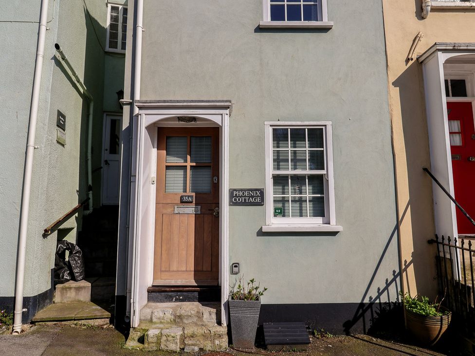 An entrance with a door and a sign at Phoenix Cottage in Lyme Regis