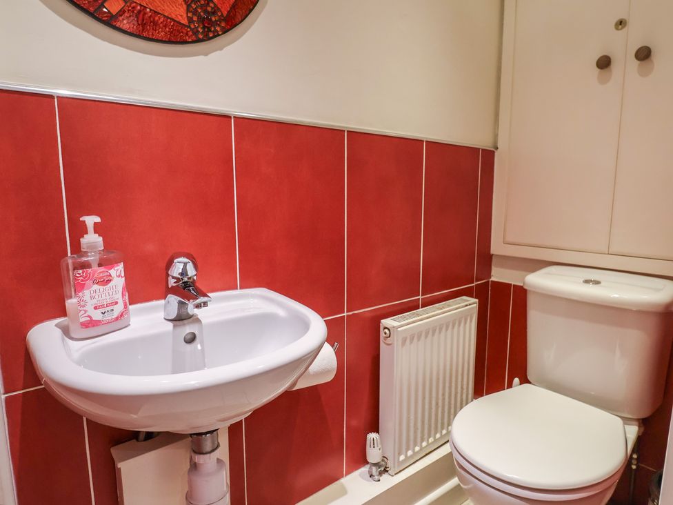 A bathroom with a sink and toilet at Phoenix Cottage Lyme Regis