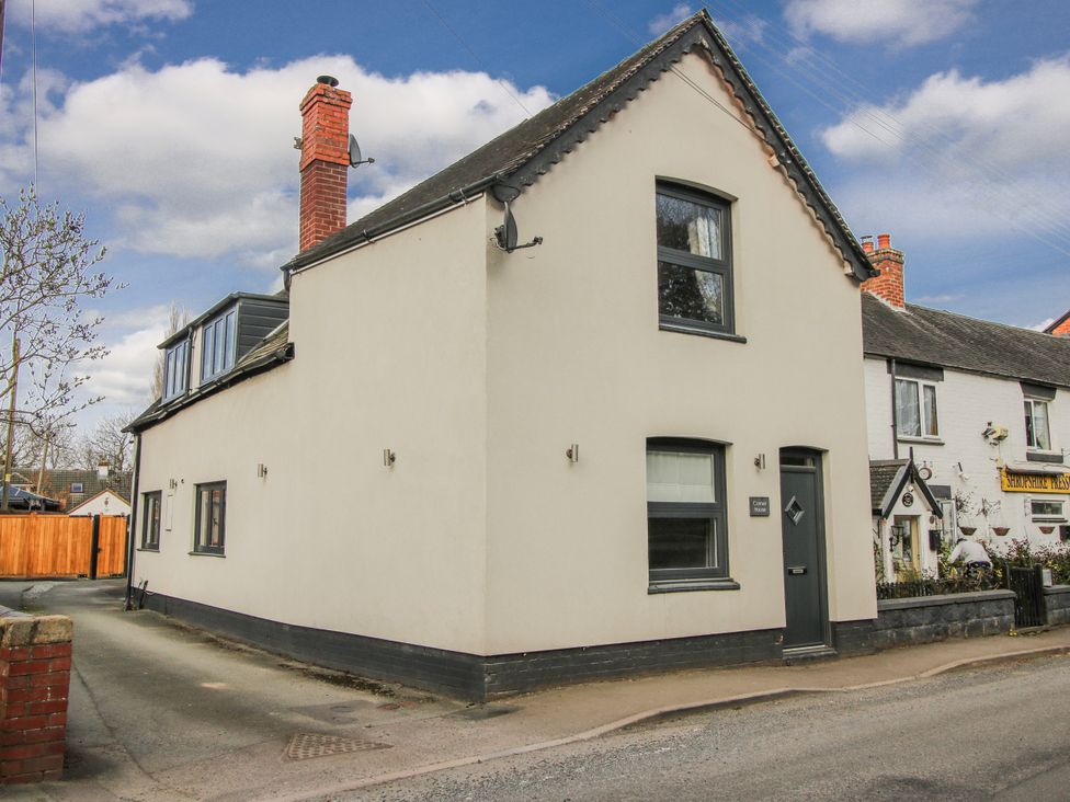 A house with a chimney and windows at Corner House in Minsterley