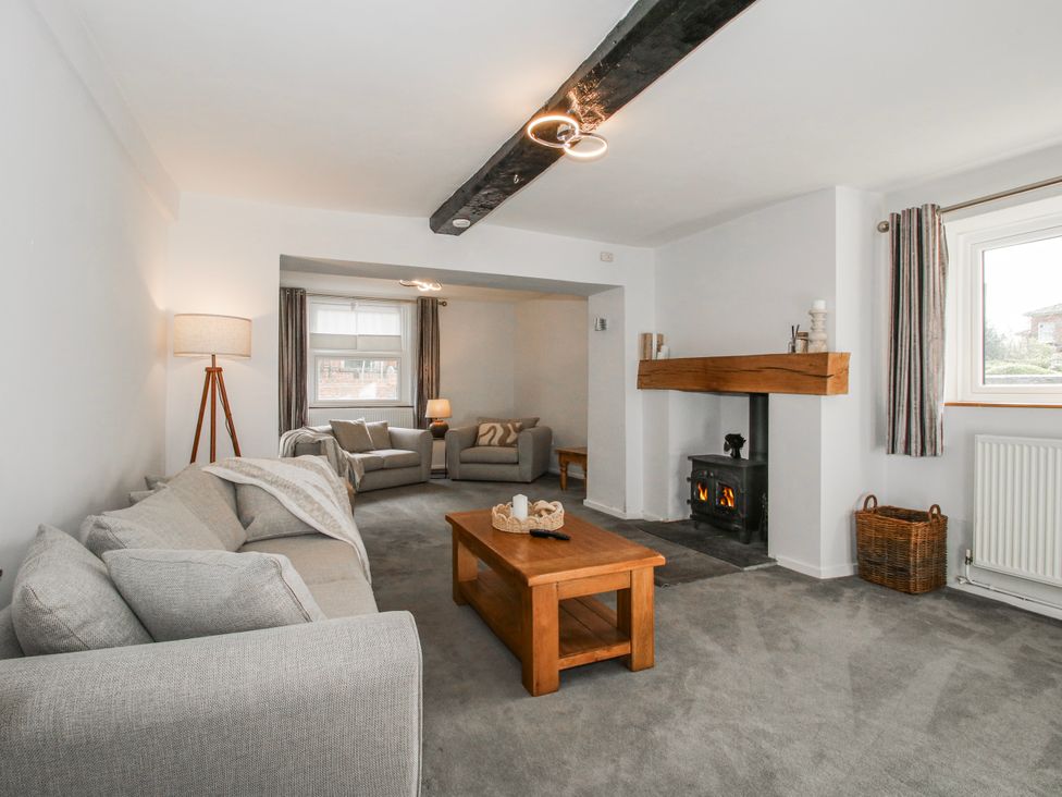 A living room with furniture and a fireplace at Corner House in Minsterley
