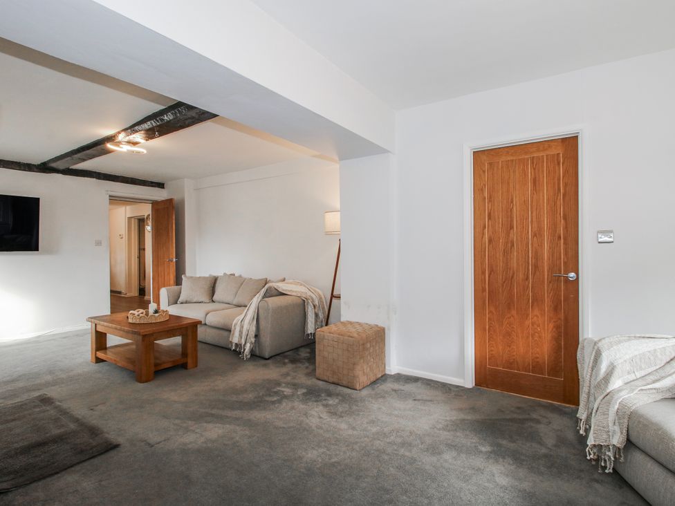 A living room with a sofa and coffee table at Corner House in Minsterley