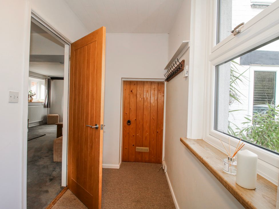 A hallway with a door and window at Corner House in Minsterley