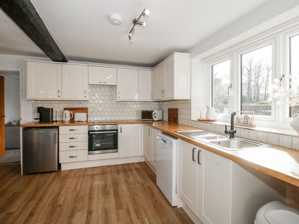 A kitchen with cabinetry and appliances at Corner House in Minsterley