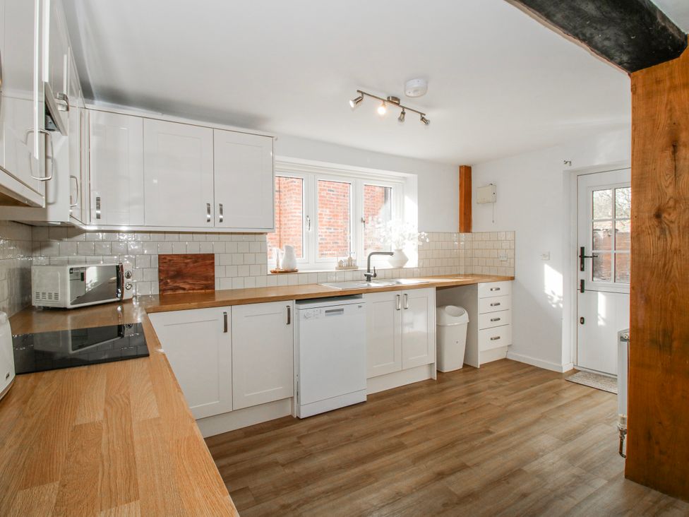 A kitchen with counter, sink, and dishwasher at Corner House Minsterley