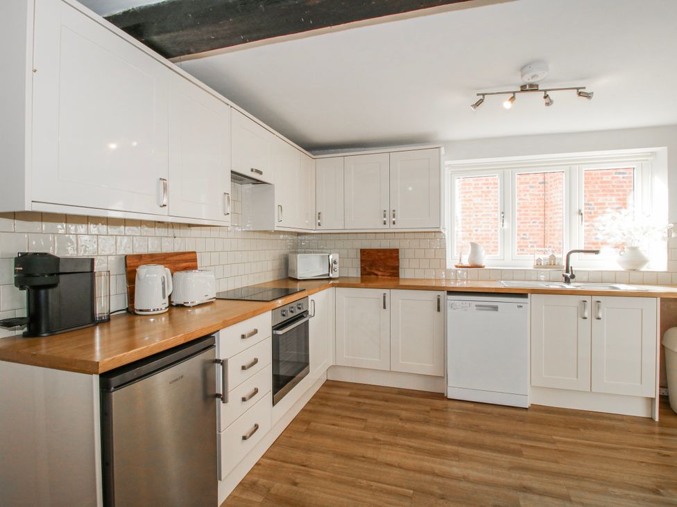 A kitchen with cabinets and appliances at Corner House Minsterley