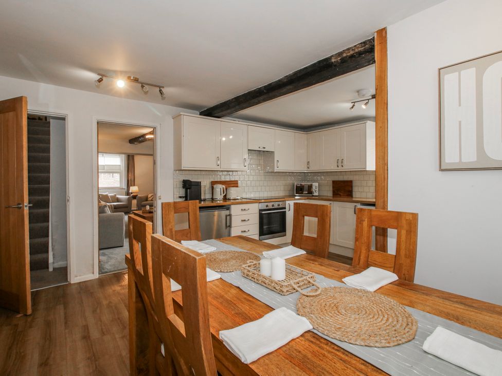 A kitchen with a dining table and chairs at Corner House in Minsterley