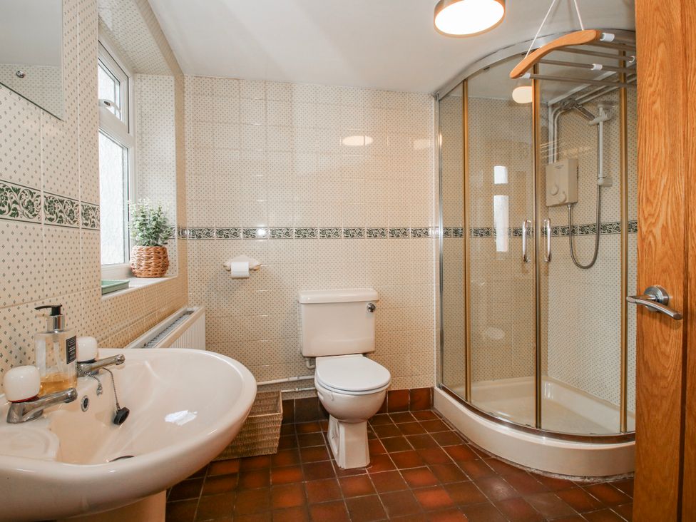 A bathroom with sink, toilet, and shower at Corner House Minsterley