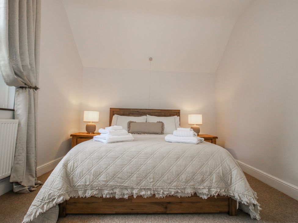 A bedroom with a bed and lamps at Corner House in Minsterley