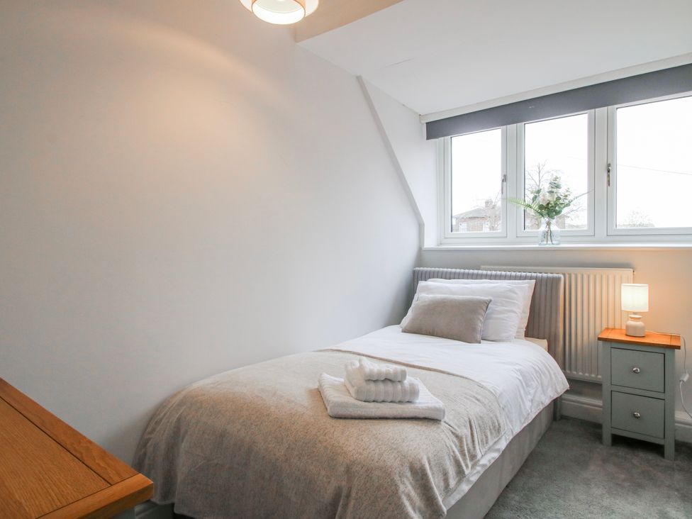 A bedroom with single bed and bedside table at Corner House in Minsterley