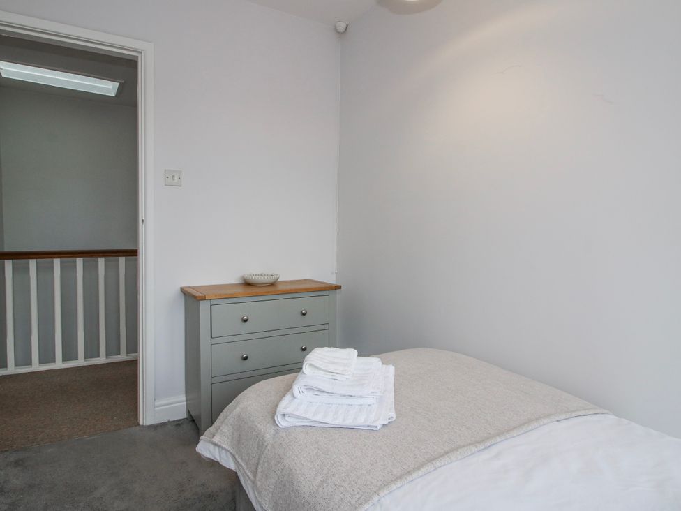 A bedroom with a bed and drawers at Corner House in Minsterley
