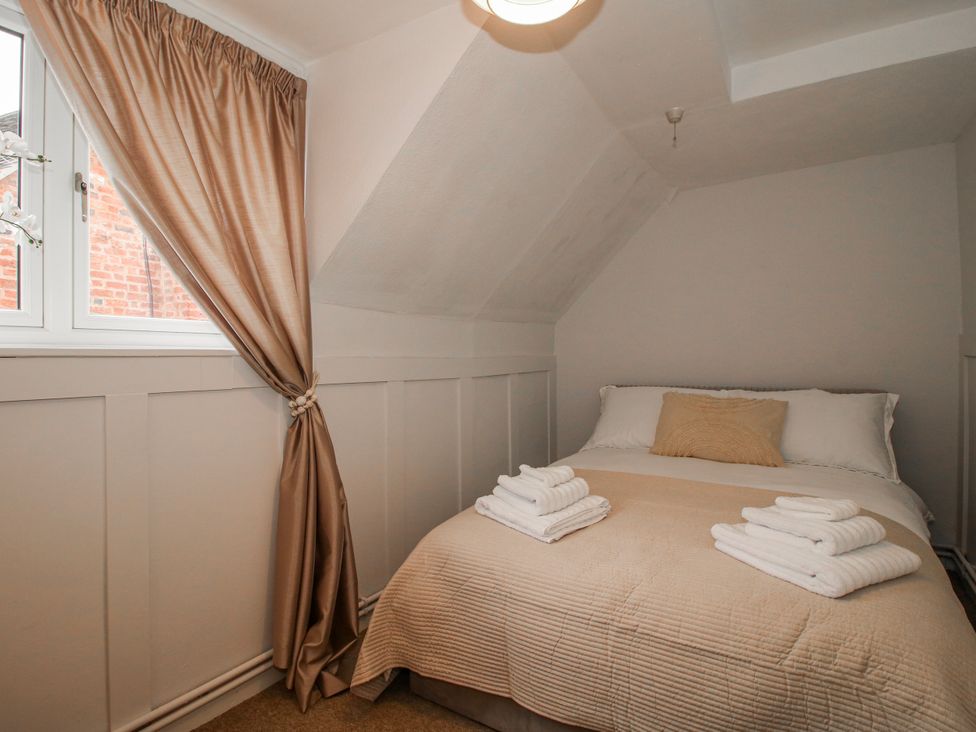 A bedroom with a bed and window at Corner House in Minsterley