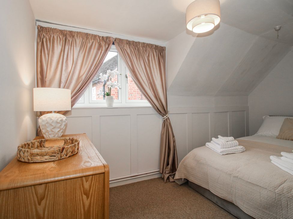 A bedroom with a bed and a window at Corner House in Minsterley