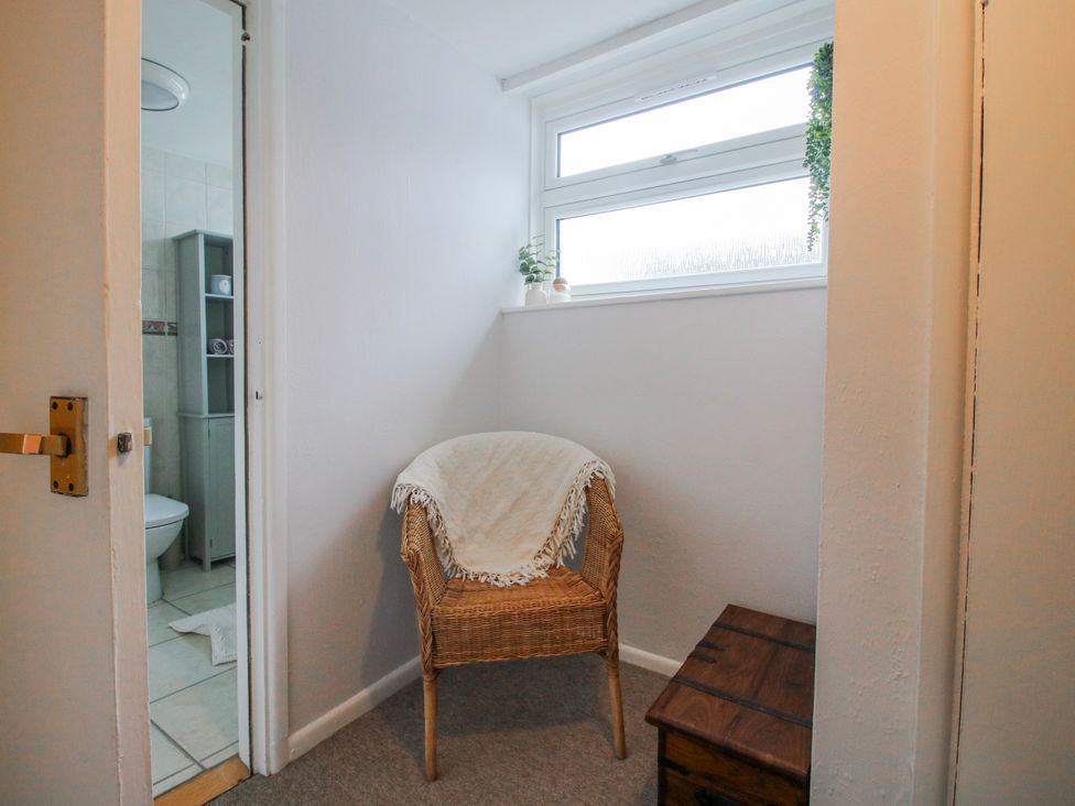 A hallway with a chair and a window at Corner House in Minsterley